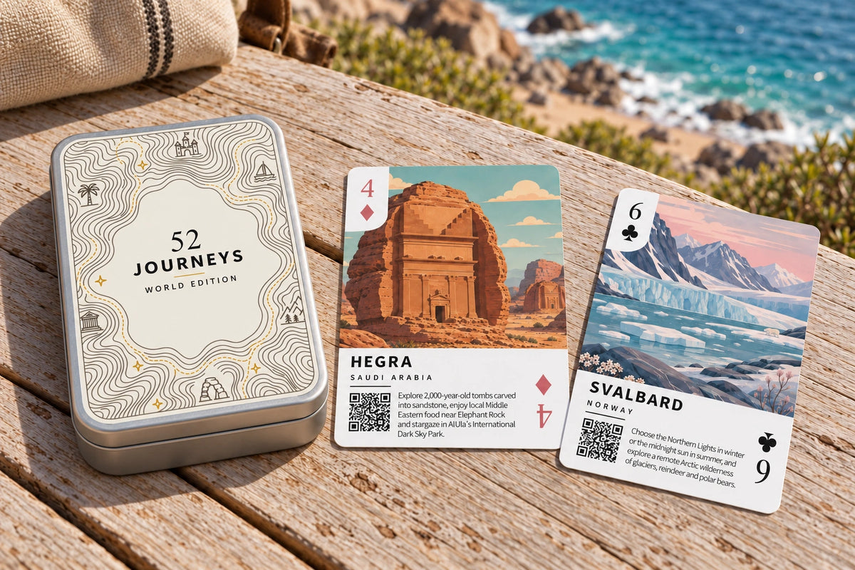 The complete World Edition tin with Hegra and Svalbard cards resting on a coastal table